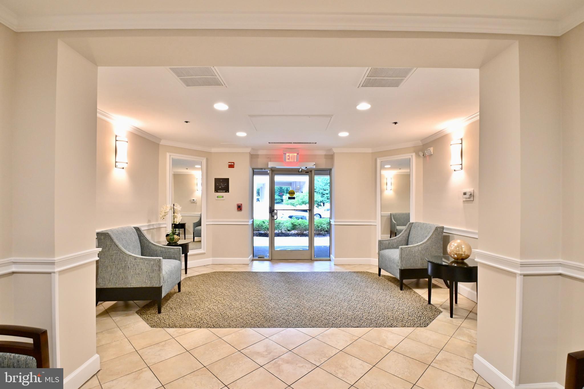 11775 Stratford House Place, Unit 104 Reston, VA 20190 - Photo 4 of 34 a living room with furniture and wooden floor