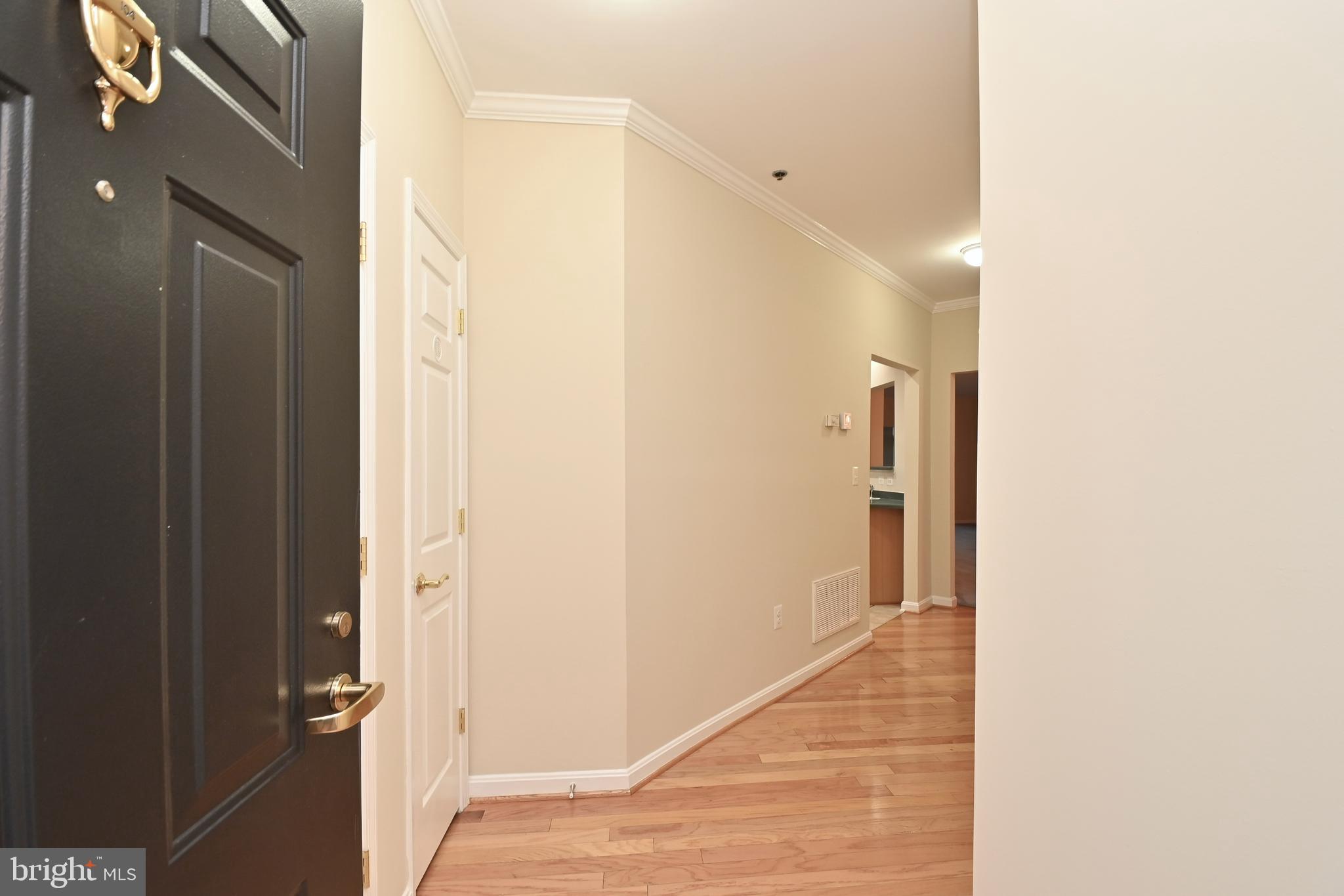 11775 Stratford House Place, Unit 104 Reston, VA 20190 - Photo 5 of 34 a view of a hallway with a white door