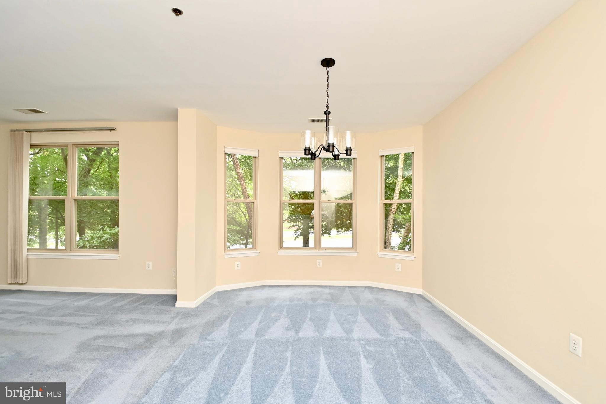 11775 Stratford House Place, Unit 104 Reston, VA 20190 - Photo 8 of 34 a view of an empty room with windows