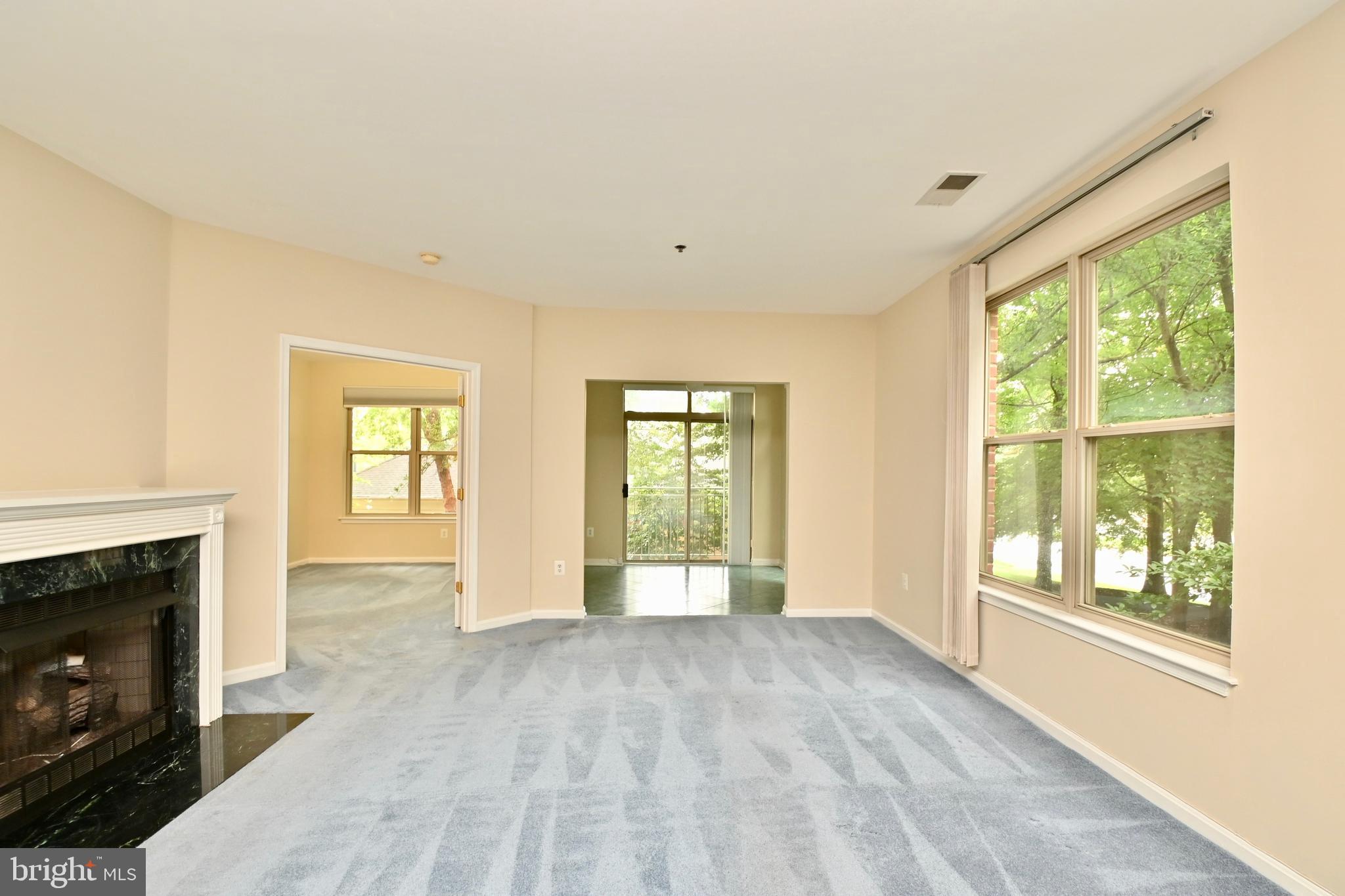 11775 Stratford House Place, Unit 104 Reston, VA 20190 - Photo 9 of 34 a view of an empty room with a fireplace and a window
