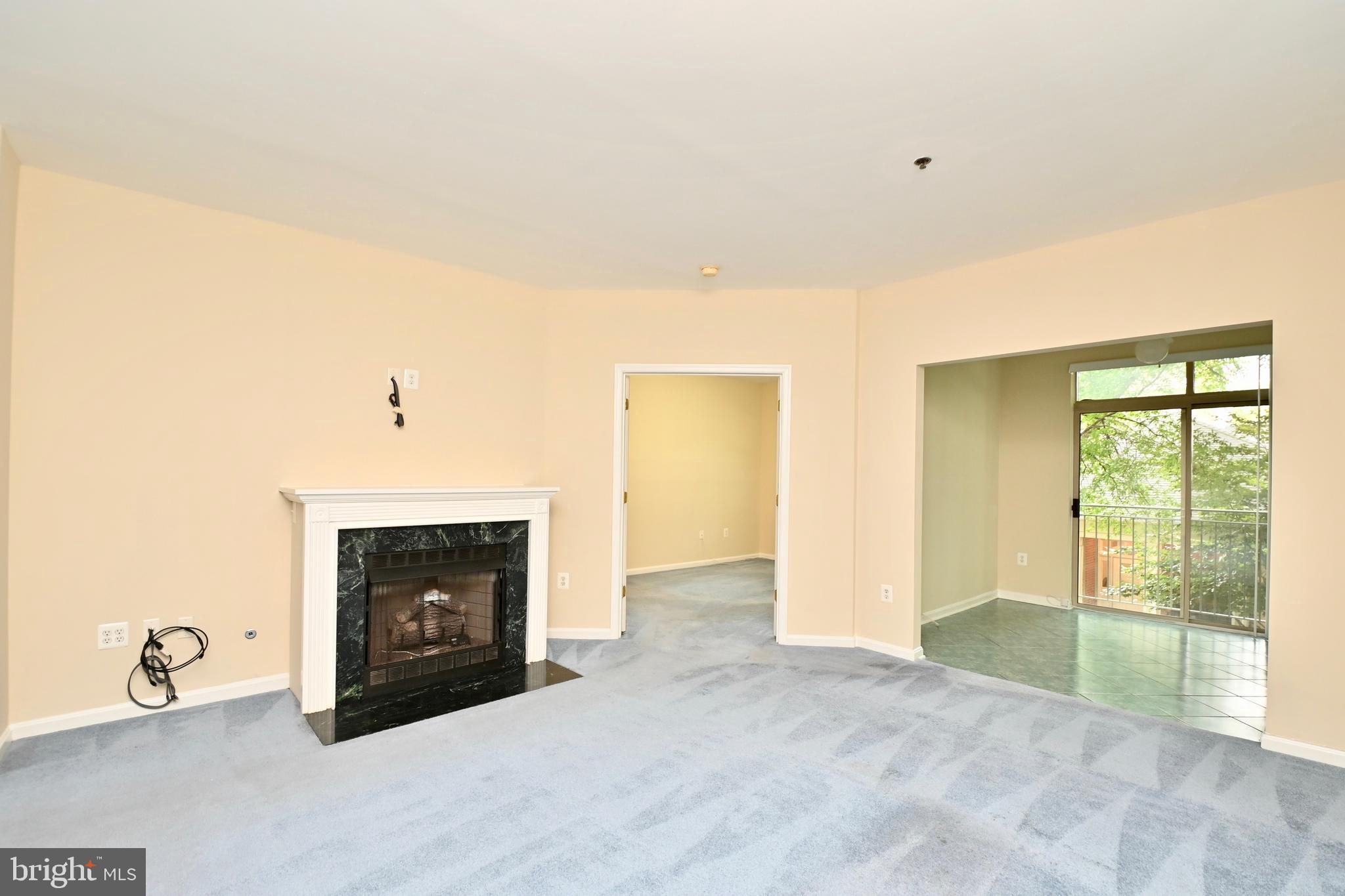 11775 Stratford House Place, Unit 104 Reston, VA 20190 - Photo 10 of 34 a view of an empty room with window and fire place