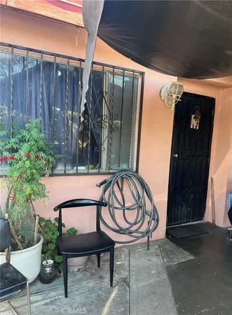 a view of a chairs and table in the patio