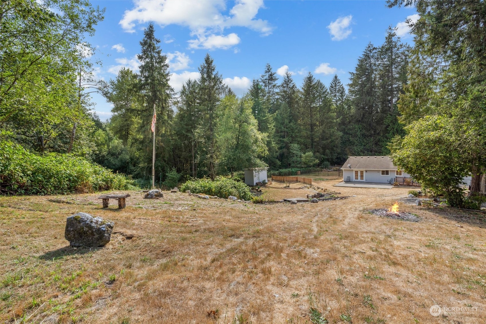 14022 Littlerock Road Southwest Rochester, WA 98579 - Photo 28 of 36 a view of a yard with swimming pool and sitting area