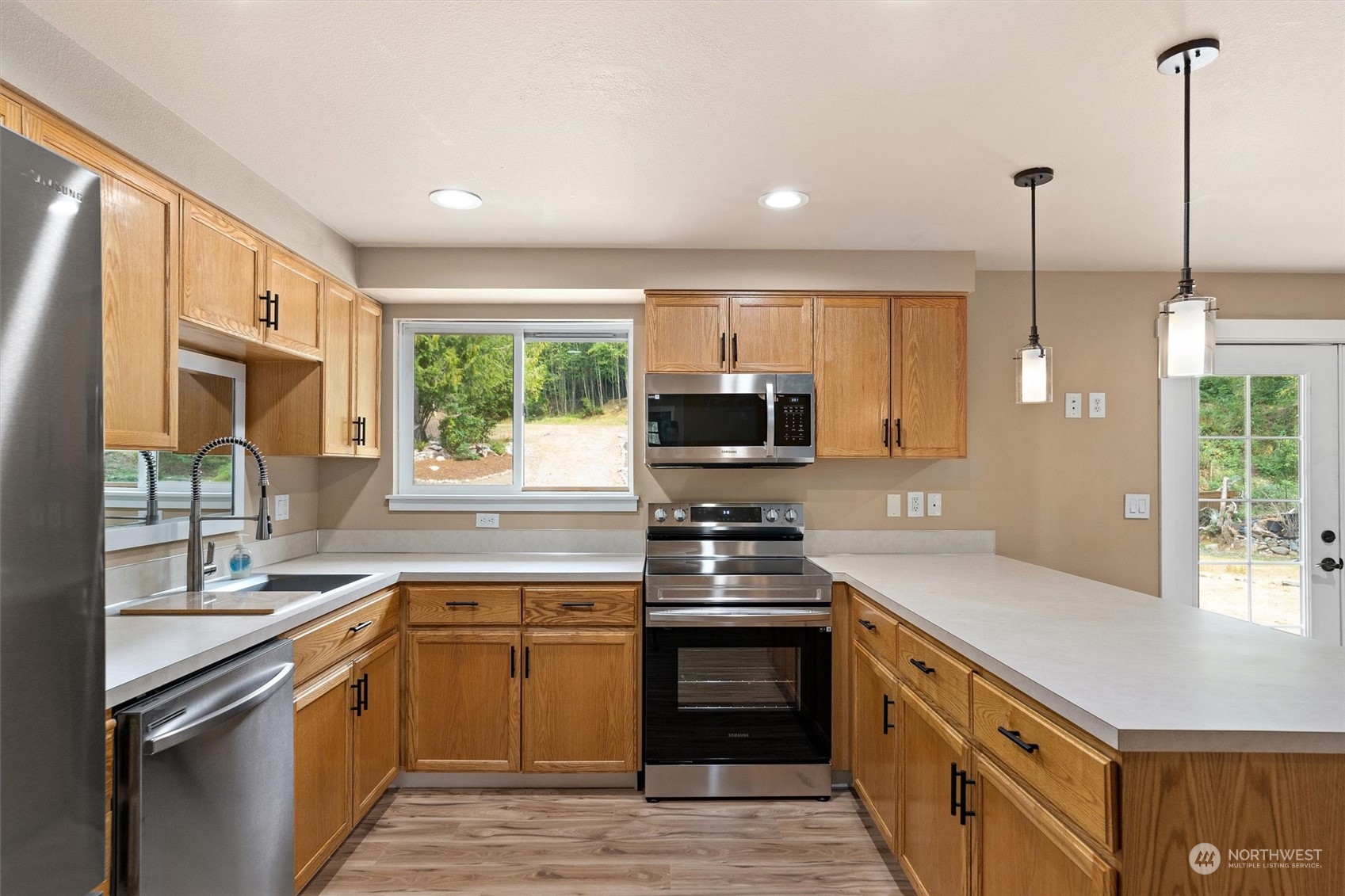 14022 Littlerock Road Southwest Rochester, WA 98579 - Photo 10 of 36 a kitchen with stainless steel appliances granite countertop a stove a sink and a refrigerator