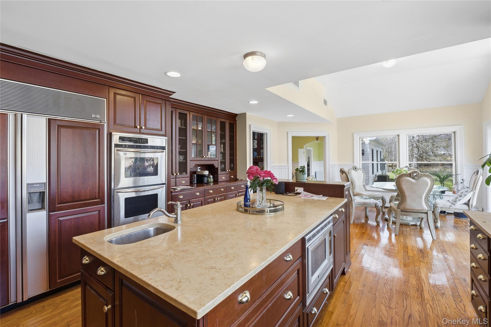 235 Centre Island Road Centre Island, NY 11771 - Photo 10 of 32 a view of a dining room with furniture a kitchen and chandelier
