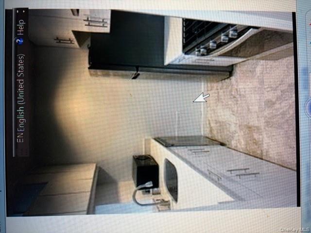 80 Elizabeth Street Manhattan, NY 10013 - Photo 2 of 2 a kitchen with a sink a refrigerator and cabinets