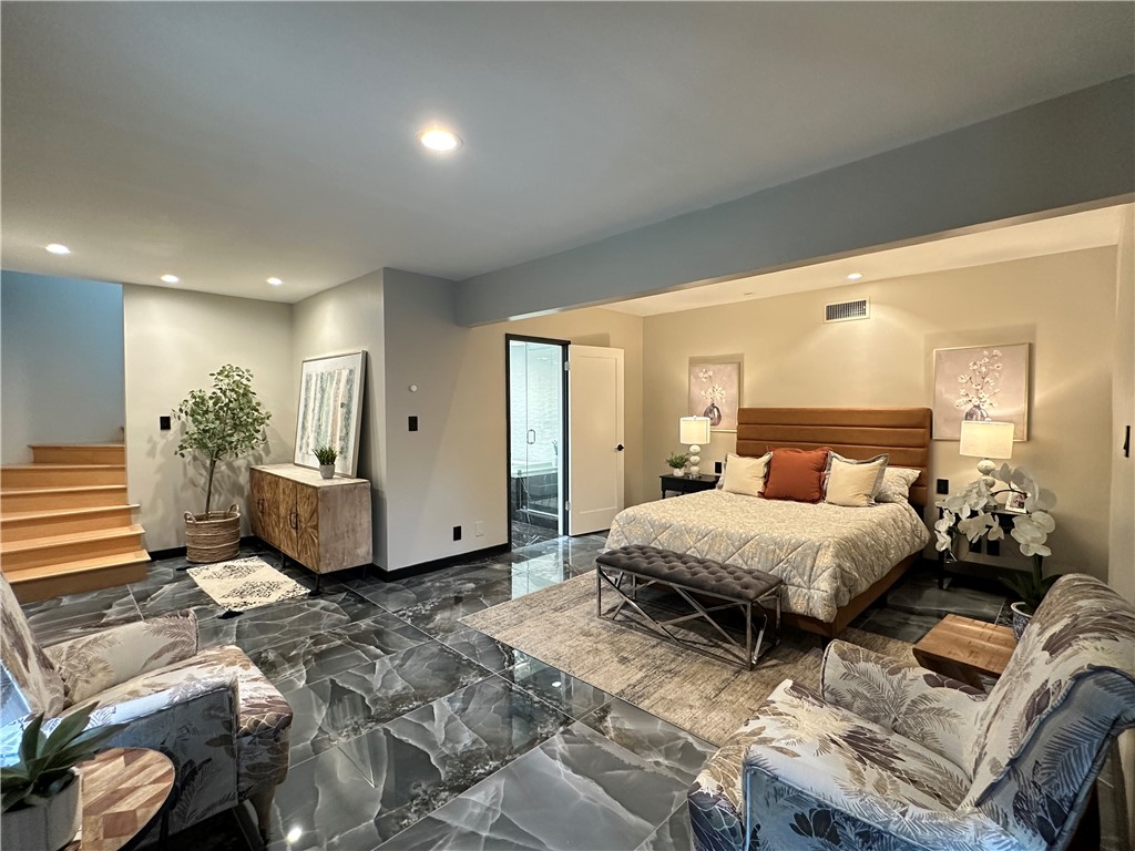 1420 Crestview Avenue Seal Beach, CA 90740 - Photo 15 of 26 a spacious bedroom with a large bed and a chandelier