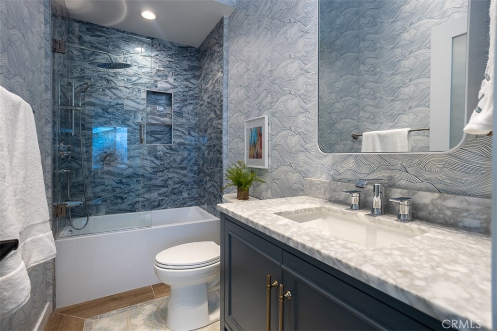 1420 Crestview Avenue Seal Beach, CA 90740 - Photo 17 of 26 a bathroom with a granite countertop sink a toilet a mirror and bathtub