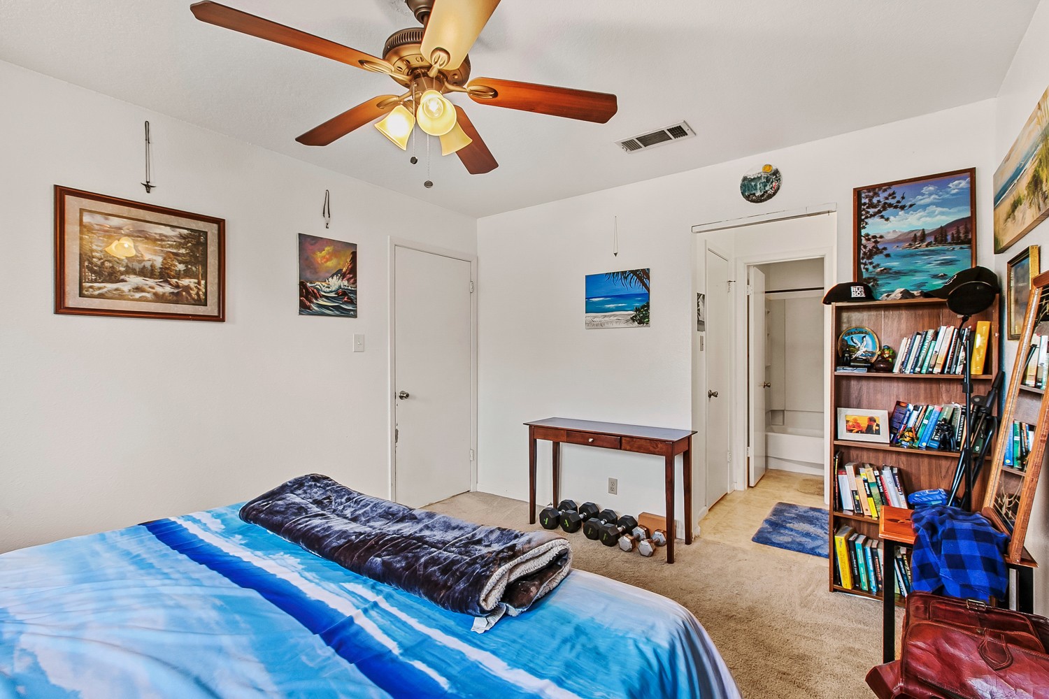6029 Old Fredericksburg Road, Unit A Austin, TX 78749 - Photo 6 of 20 a bedroom with furniture and a book shelf