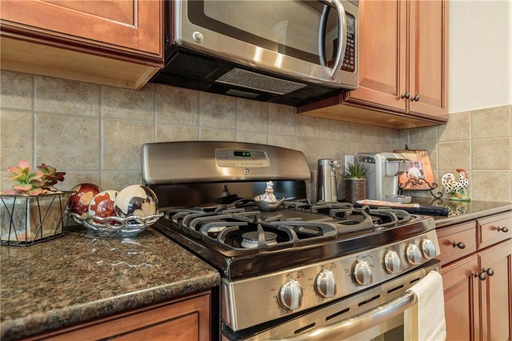 4673 Edith Street Plano, TX 75024 - Photo 17 of 35 a stove top oven sitting inside of a kitchen