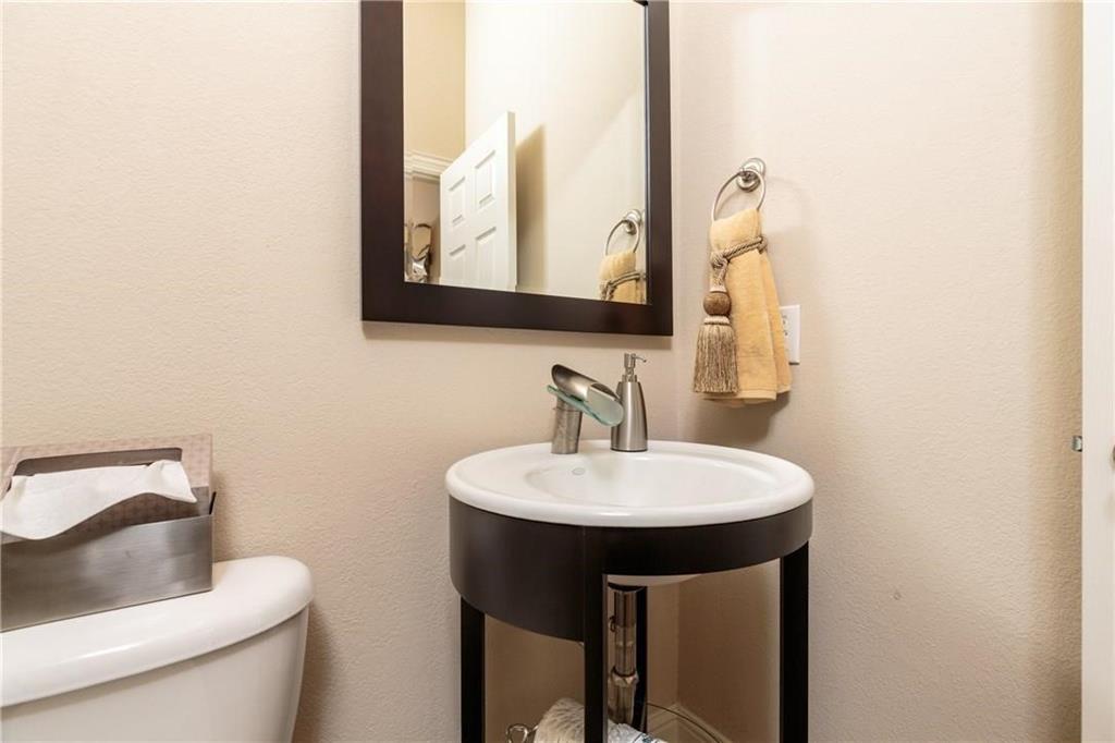 4673 Edith Street Plano, TX 75024 - Photo 24 of 35 a bathroom with a sink a toilet and mirror