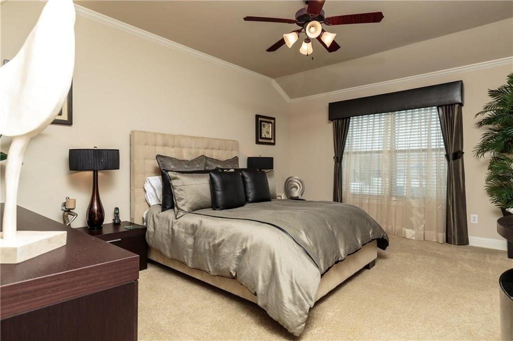 4673 Edith Street Plano, TX 75024 - Photo 26 of 35 a bedroom with a bed and a chandelier