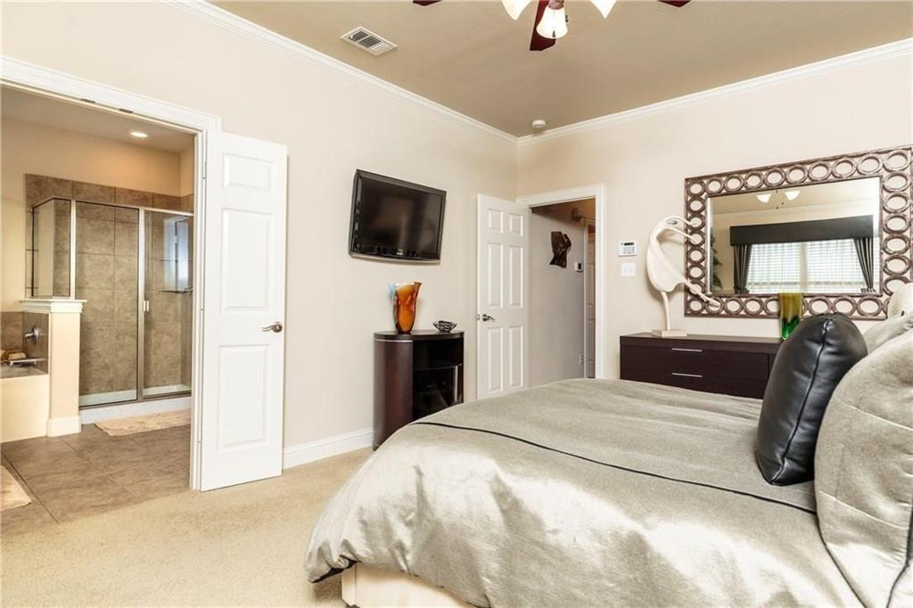 4673 Edith Street Plano, TX 75024 - Photo 28 of 35 a bedroom with a bed and a flat tv screen on dresser