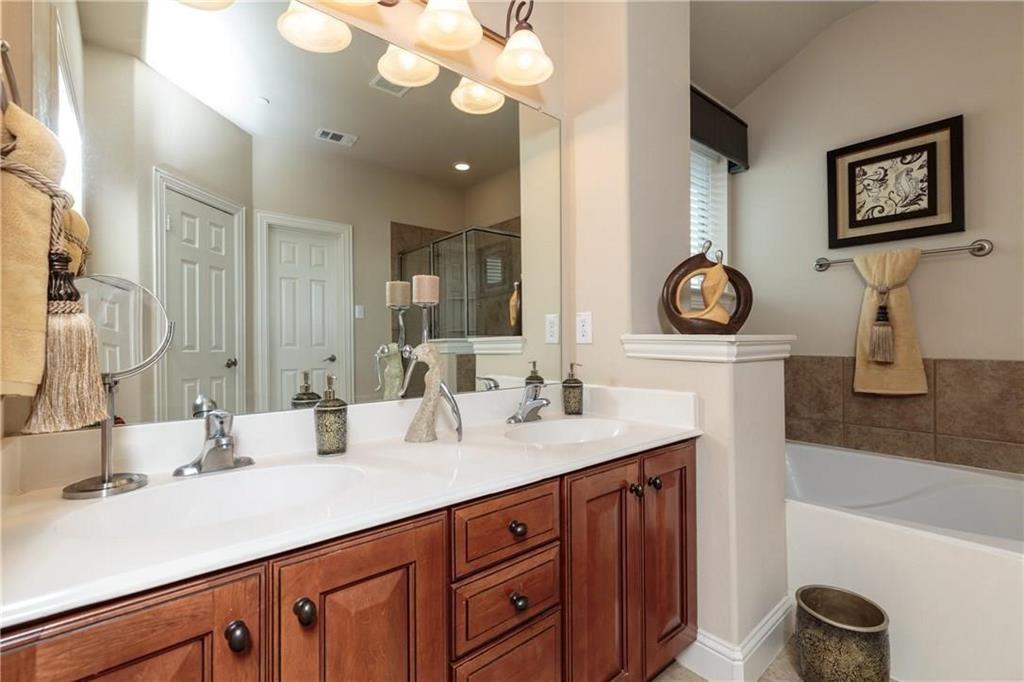 4673 Edith Street Plano, TX 75024 - Photo 29 of 35 a bathroom with double vanity sink and a mirror