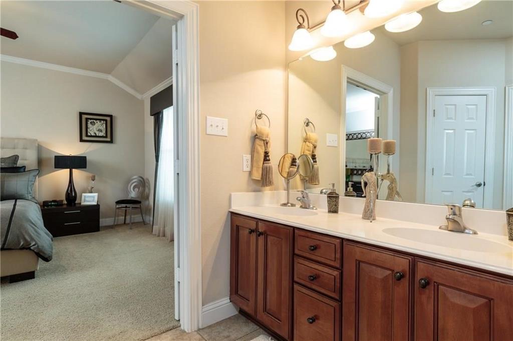 4673 Edith Street Plano, TX 75024 - Photo 31 of 35 a en suite bathroom with double sink and a mirror