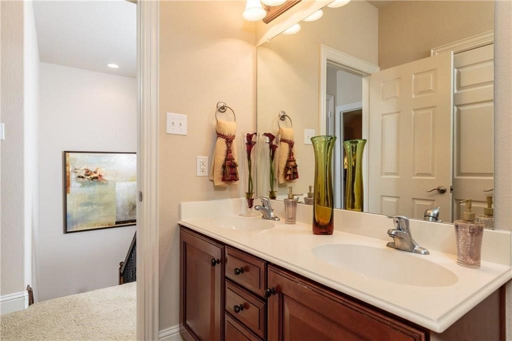 4673 Edith Street Plano, TX 75024 - Photo 33 of 35 a bathroom with a sink vanity and a mirror