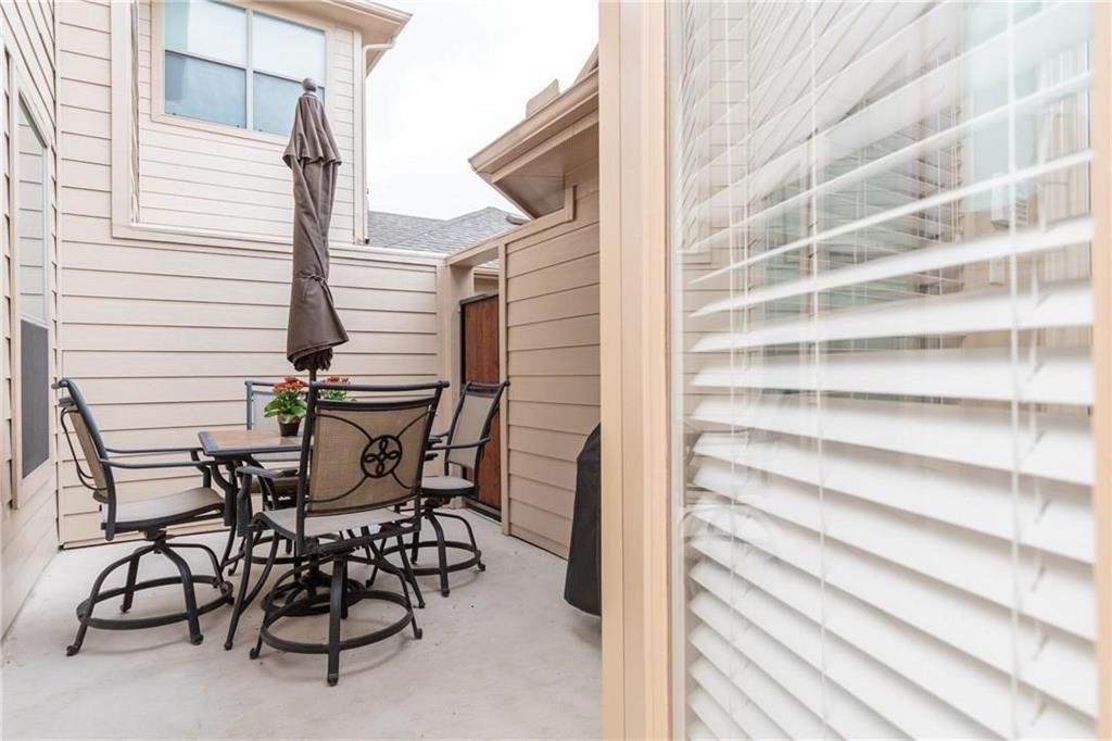 4673 Edith Street Plano, TX 75024 - Photo 35 of 35 a view of a patio with table and chairs and wooden floor