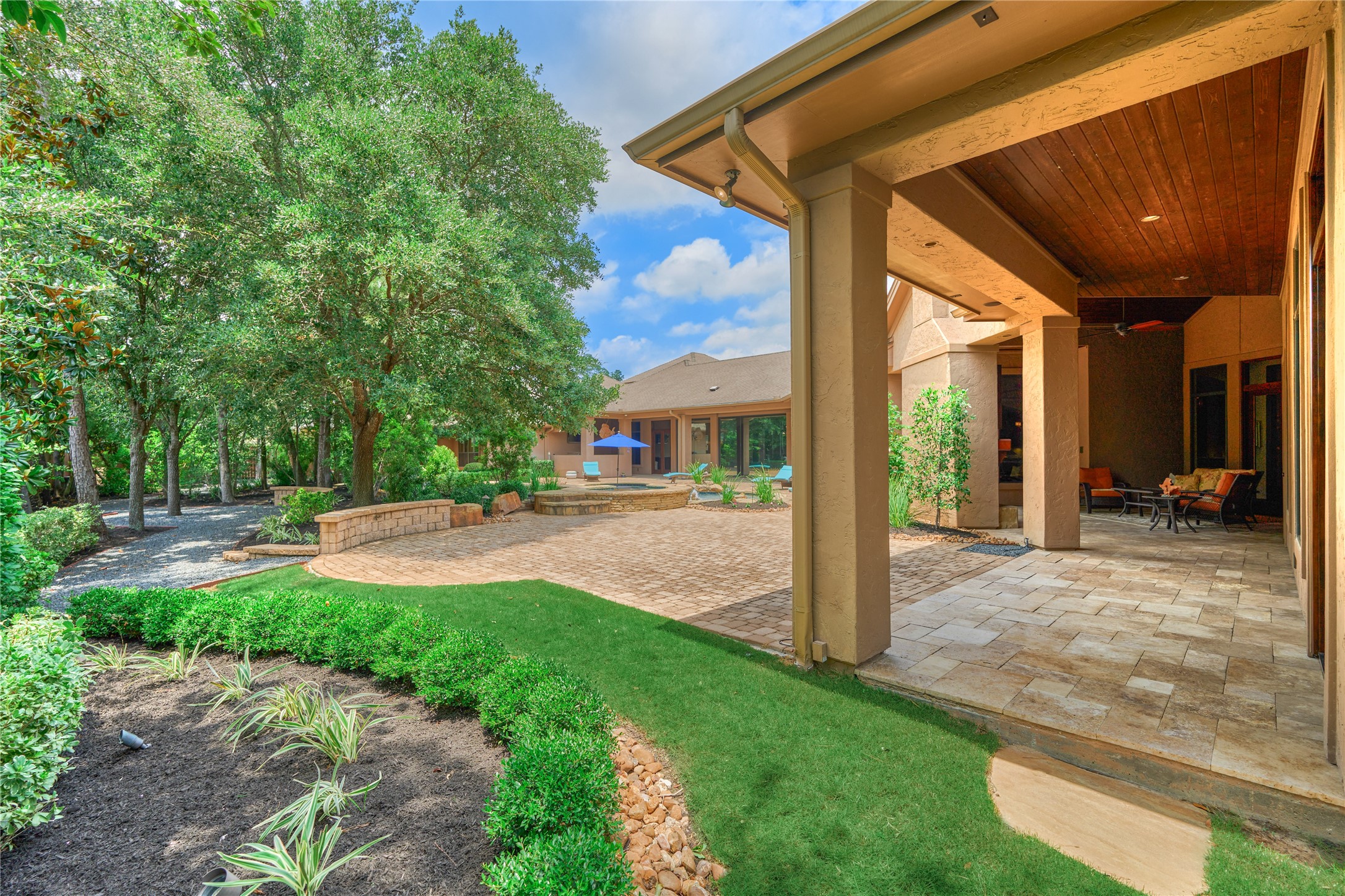 24803 Pearl Crest Lane Spring, TX 77389 - Photo 4 of 50 Pristine backyard retreat features Black Star gravel walkways, creating peaceful and scenic pathways throughout the grounds.