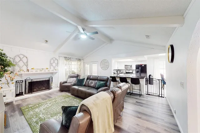a kitchen with sink a microwave and cabinets