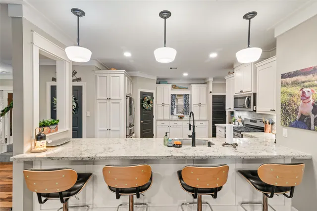 a view of a kitchen with a dining table and chairs