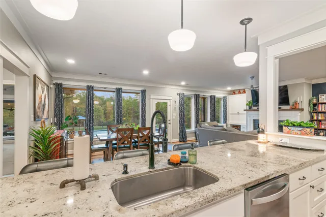 a kitchen with granite countertop a sink and a large window