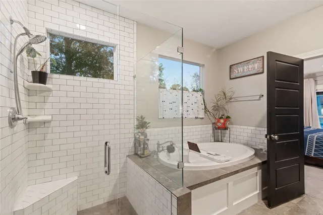 a bathroom with a granite countertop sink a toilet and shower