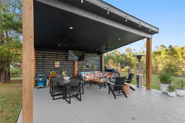 a view of a patio with table and chairs and potted plants