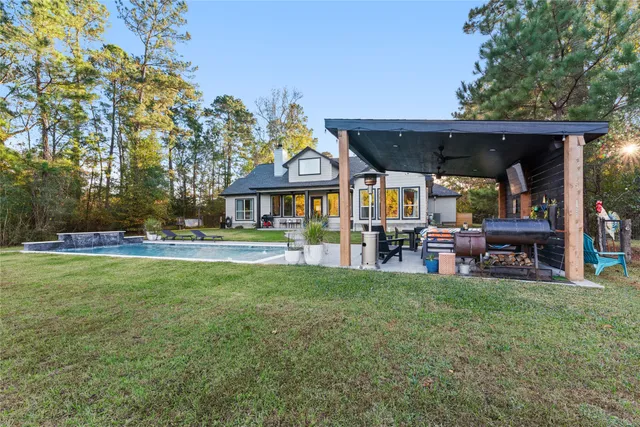 a view of a house with backyard porch and sitting area