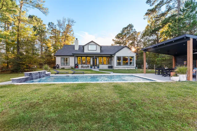 a front view of a house with a yard table and chairs