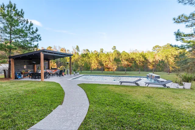 a view of swimming pool and outdoor seating