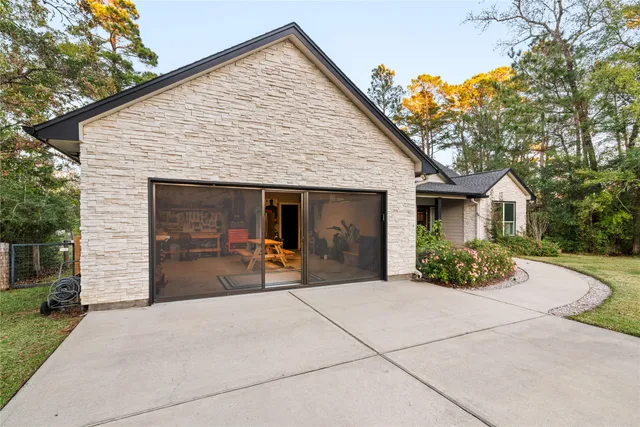 a living room with furniture a flat screen tv and a window