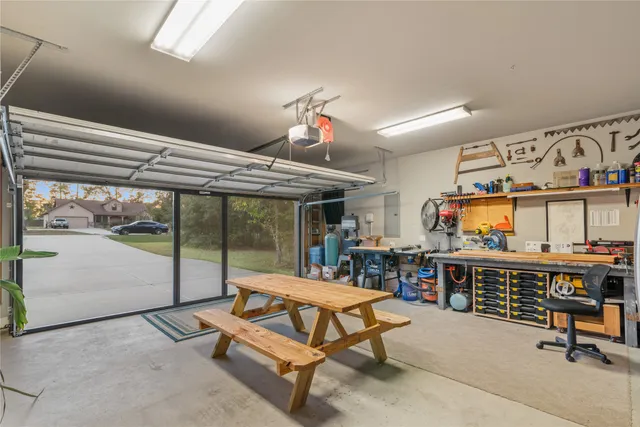 a view of a patio with a table and chairs under an umbrella