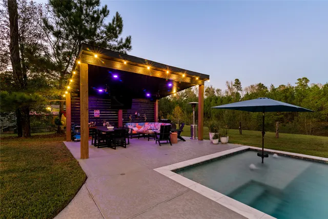 a view of a swimming pool with an outdoor space and seating area