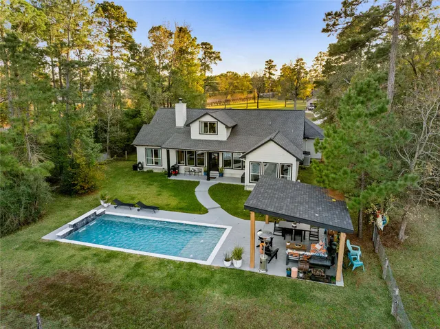 an aerial view of a house with a yard and garden