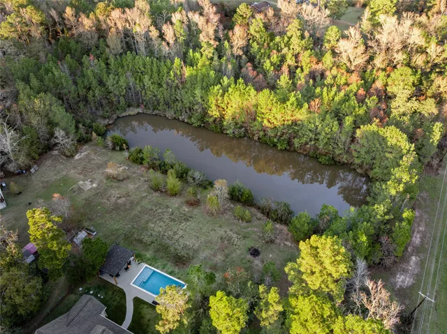 an aerial view of a house with a yard table and chairs