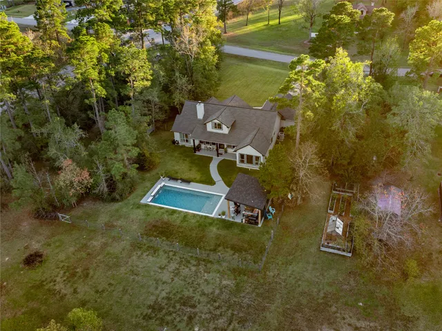 an aerial view of a house with a yard