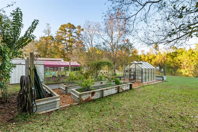 a view of house with backyard and garden