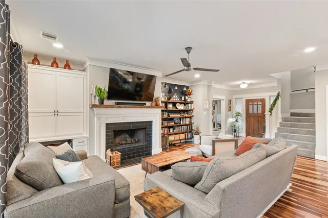 a living room with furniture a flat screen tv and a fireplace