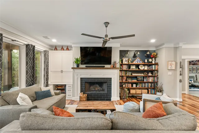 a living room with furniture a flat screen tv and a fireplace