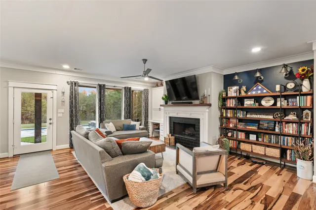 a living room with furniture a fireplace and a flat screen tv
