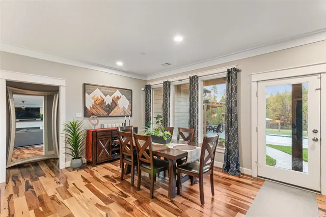 a view of a dining room with furniture large window and outside view