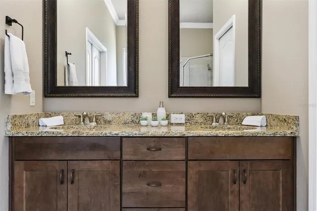 a bathroom with double sink and mirror