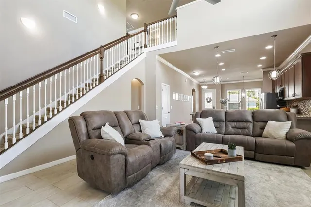 a living room with furniture and a ceiling fan