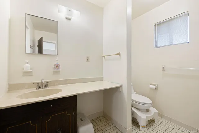 a bathroom with a sink toilet a mirror and shower