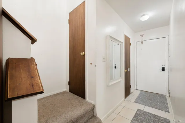 a view of a hallway with wooden floor and closet