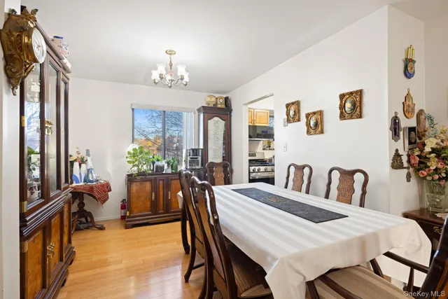 a view of a dining room with furniture and a chandelier