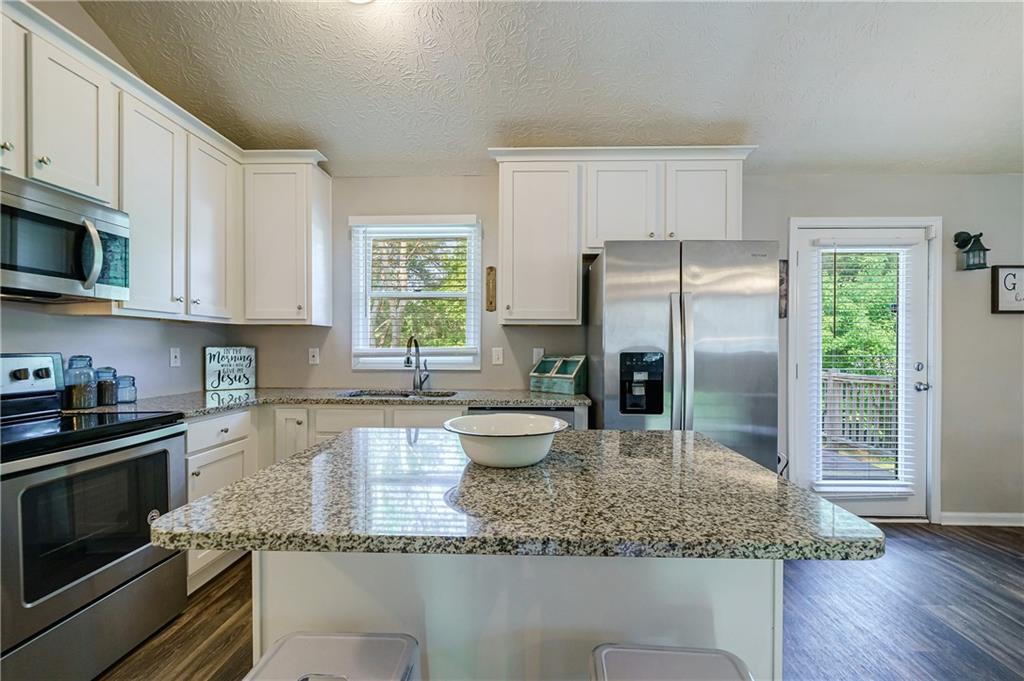 1194 Roscoe Road Newnan, GA 30263 - Photo 1 of 1 a kitchen with a stove a sink and a refrigerator