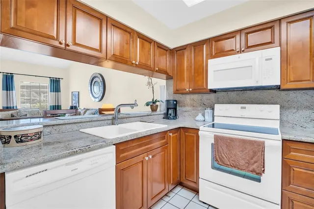 a kitchen with stainless steel appliances granite countertop a sink and cabinets