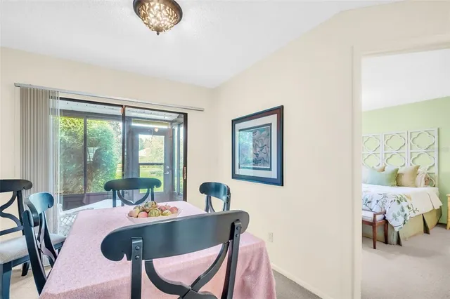 a dining room with furniture and a large window