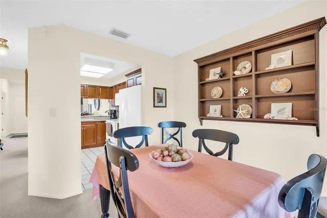 a view of a dining room with furniture and a window